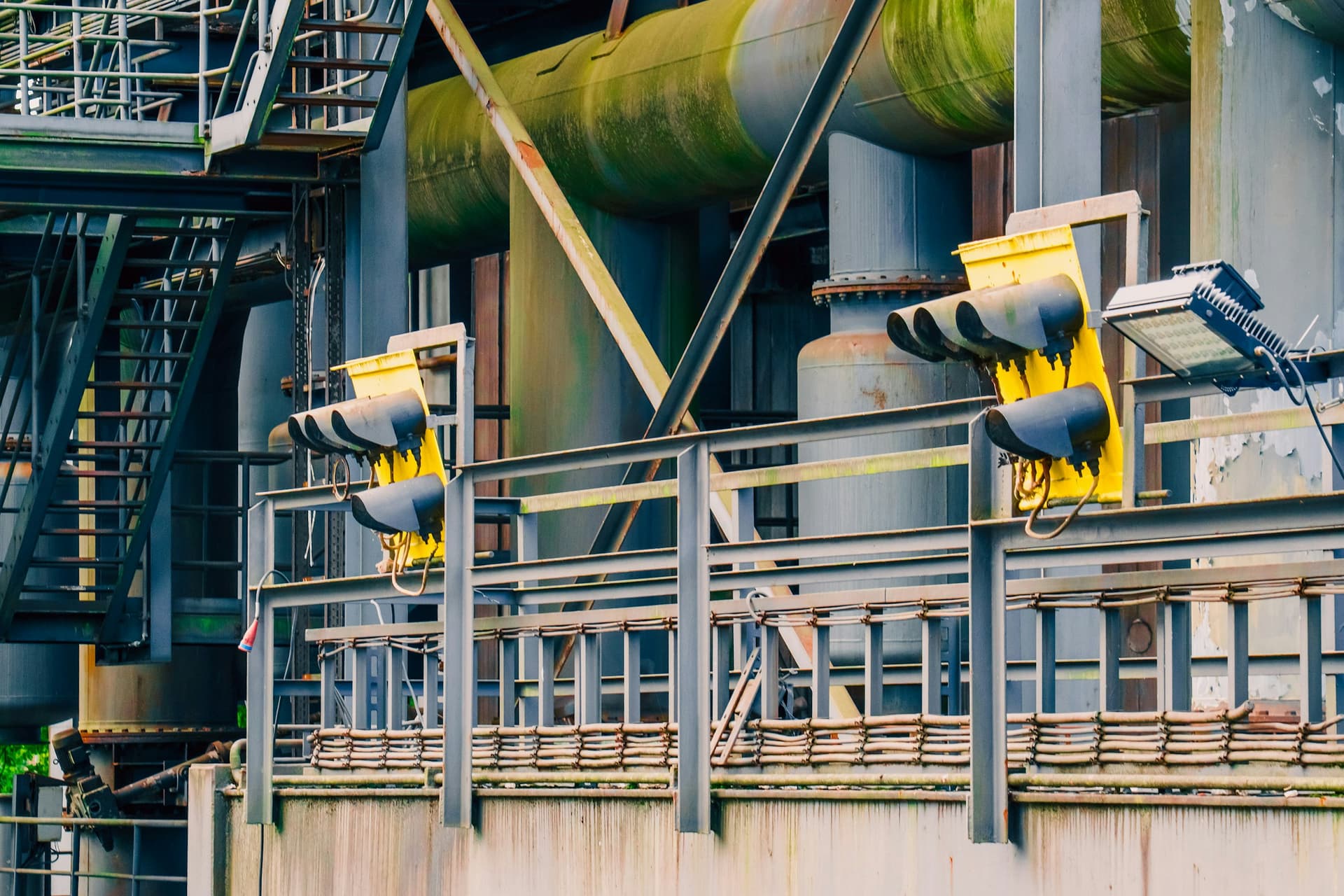 Industrial factory complex rusted steel structures pipes ladders heavy machinery architecture wallpaper background. Abandoned manufacture plant construction wea
